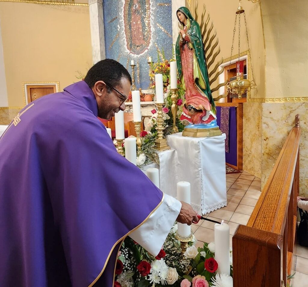 Fr. Fabio dos Santos lighting the candles for the 2025 OLG novena