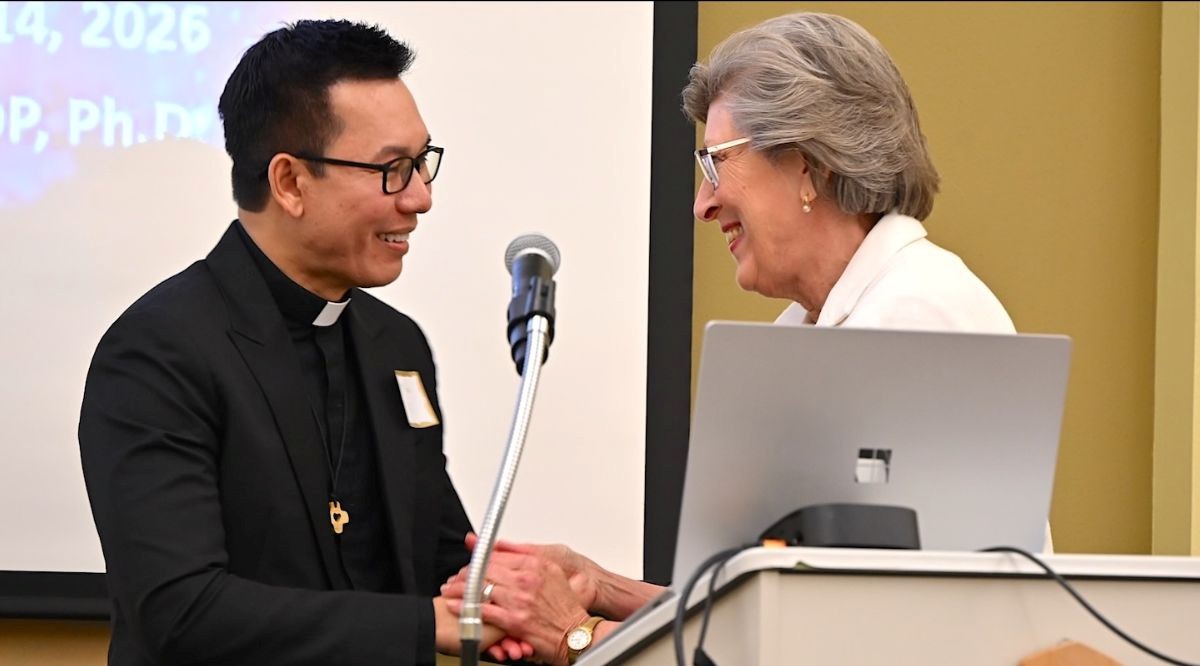 Fr. Vien Nguyen, SCJ, welcomes his former professor, Sr. Barbara Reid, OP, to the gathering of religious leadership.